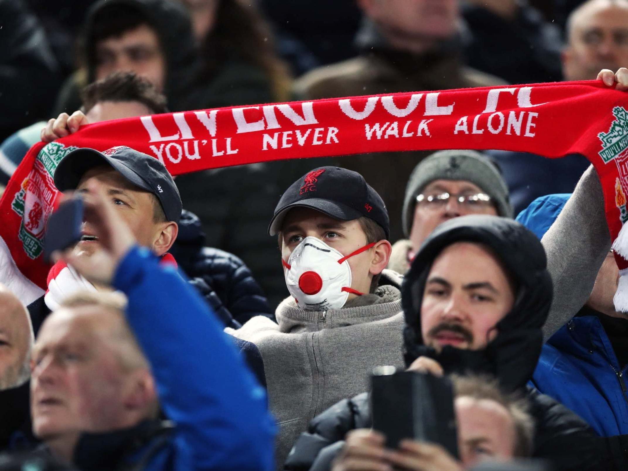 A Liverpool fan wearing a protective mask at Anfield in March