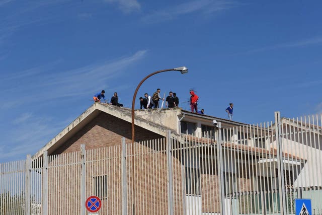Inmates gather on the roof of the prison during a prison riot in Foggia