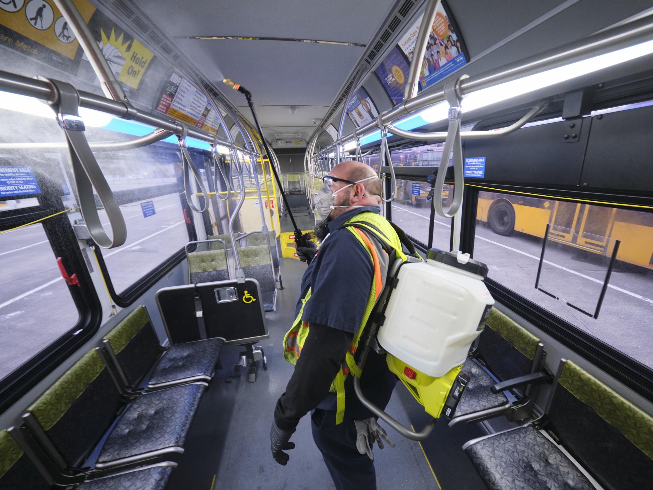A Seattle bus is sprayed with disinfectant in response to the outbreak of Covid-19 in Washington state