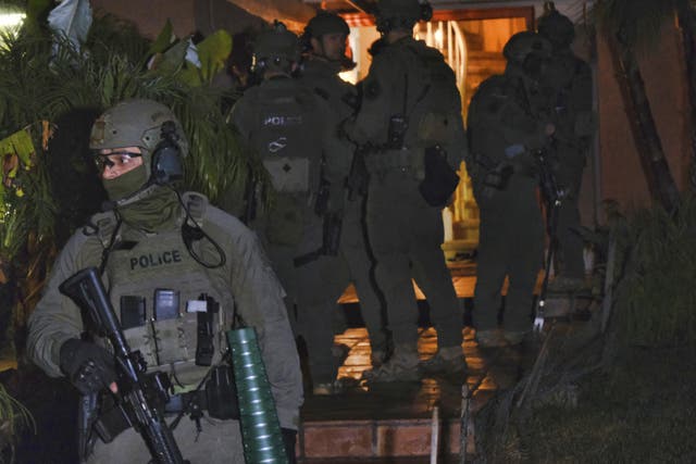 DEA agents search a residential house during an arrest of a suspected drug trafficker on 11 March, 2020 in Diamond Bar, California as part of Project Python, aimed at dismantling the Jalisco New Generation Cartel, known as CJNG.
