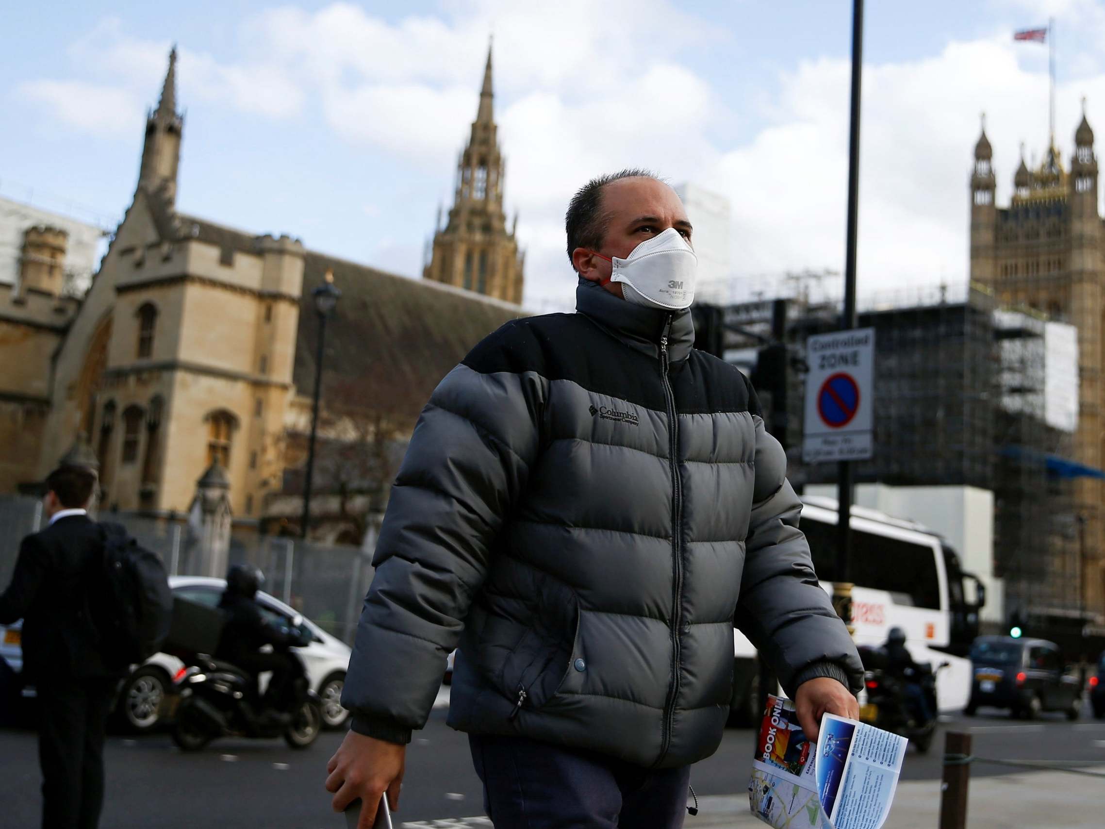 A man wearing a protective face mask outside the Houses of Parliament