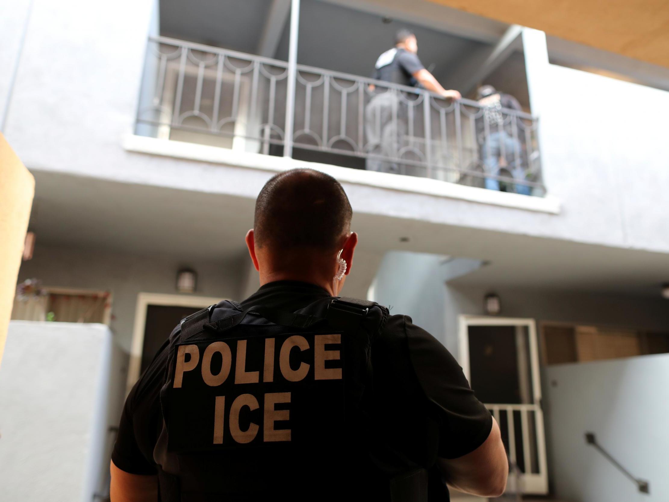 An officer with the US Immigration and Customs Enforcement's (ICE) Fugitive Operations team search for a Mexican national at a home in Hawthorne, California, U.S., March 1, 2020.
