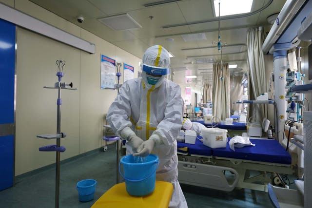 Medical workers in protective suits disinfect an intensive care unit (ICU) ward of Union Jiangbei Hospital in Wuhan