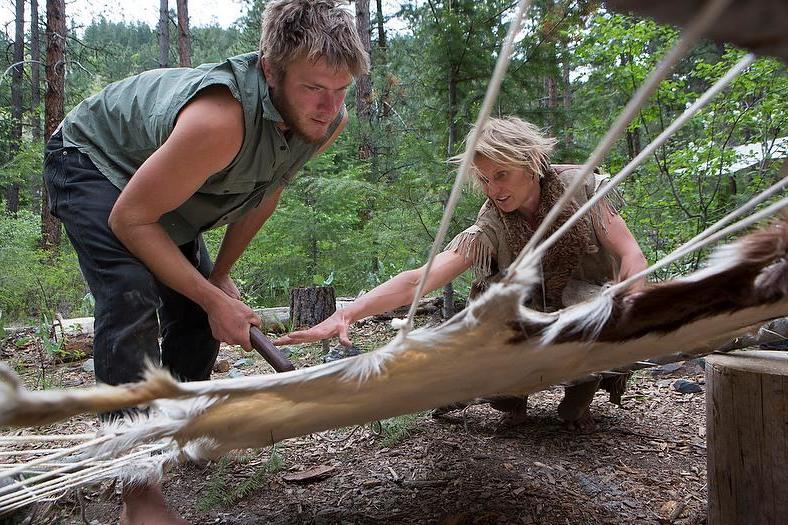 A camper learns how to process a deer hide using a hump bone