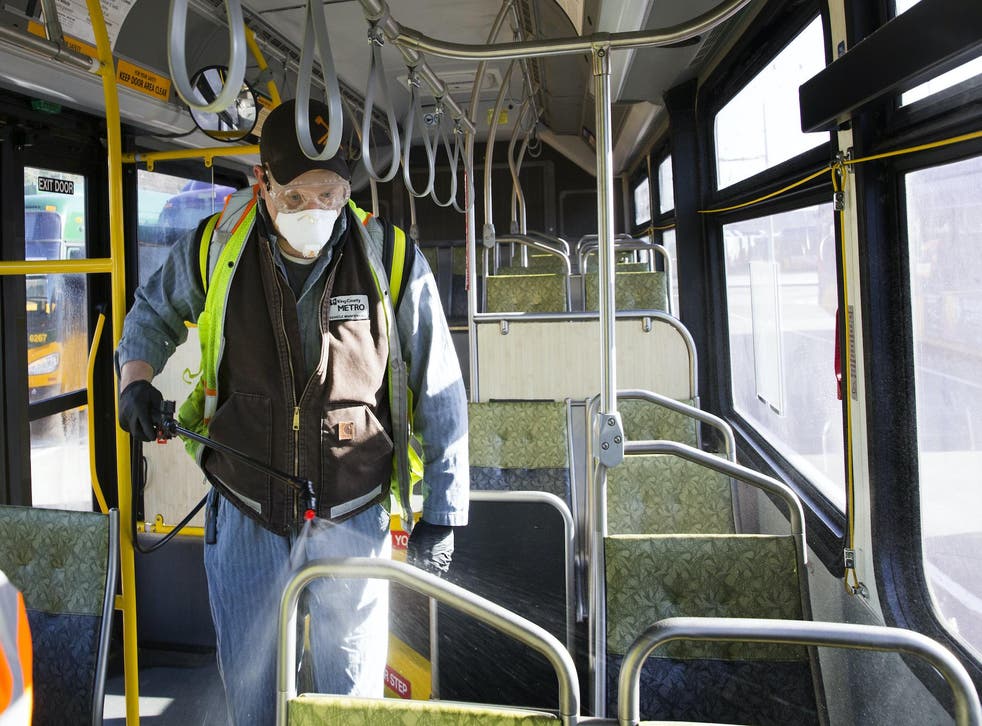 Larry Bowles, an equipment service worker for King County Metro, sprays Virex II 256, a disinfectant, throughout a metro bus at the King County Metro Atlantic/Central operating base on March 4, 2020 in Seattle, Washington