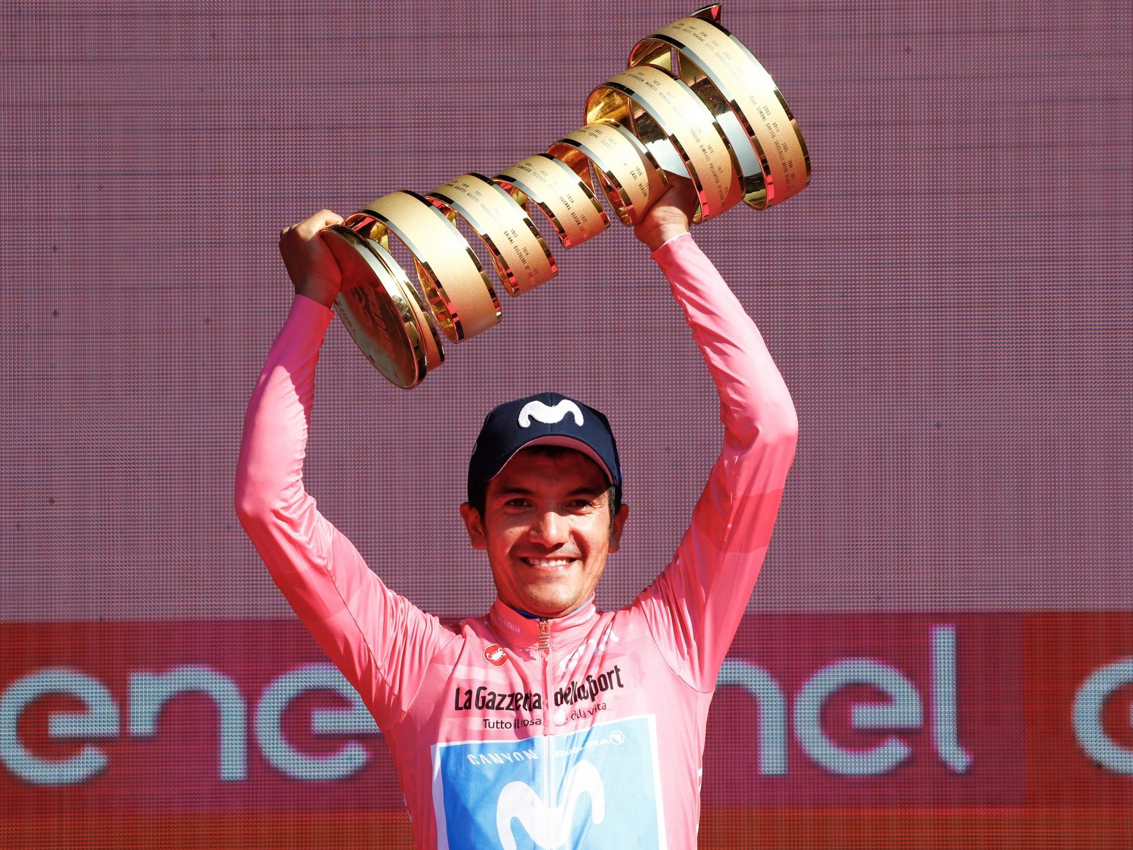 Richard Carapaz lifts the trophy after winning the general classification
