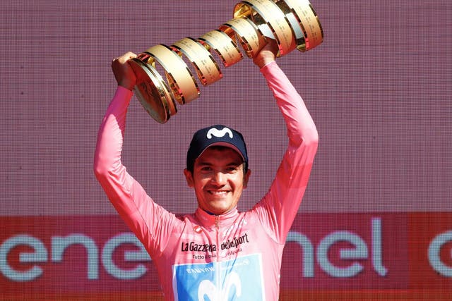 Richard Carapaz lifts the trophy after winning the general classification