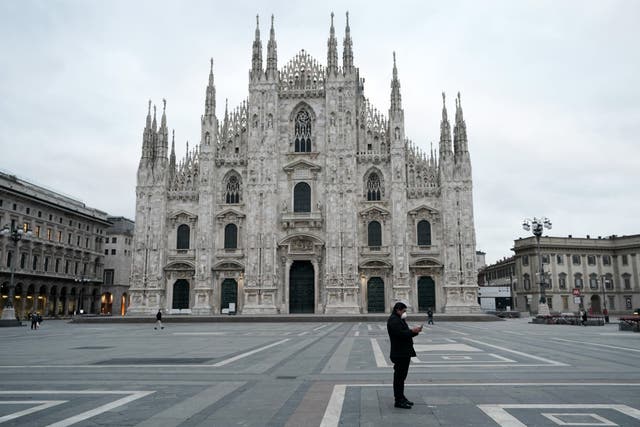 A man is pictured wearing a protective mask in Milan, Italy, on Thursday