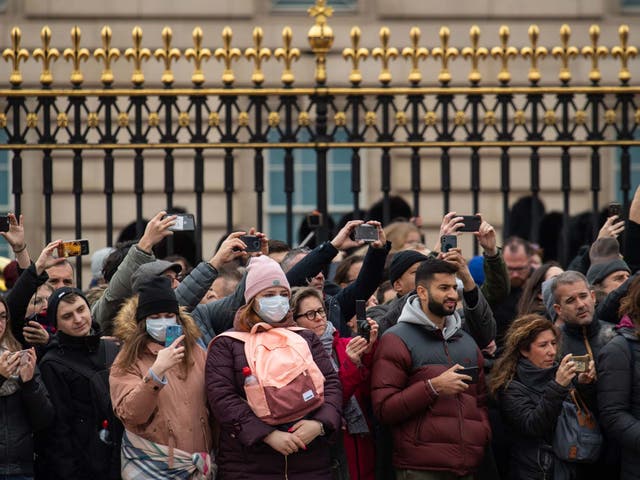 Tourists outside Buckingham Palace in London: it's thought up to 10,000 people in the UK could be infected