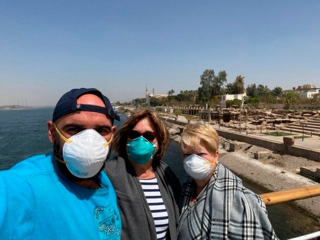 A photo taken by Javier Parodi shows Javier Paroid, Grissel Parodi and Amy Khamissian (left-to-right) aboard the MS Asarade in Luxor Egypt on 10 March 2020 (AP)
