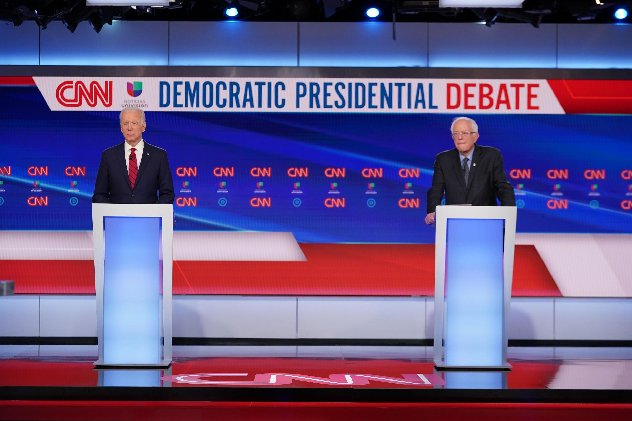 Democratic presidential hopefuls Joe Biden (L) and Bernie Sanders take part in the 11th Democratic Party 2020 presidential debate