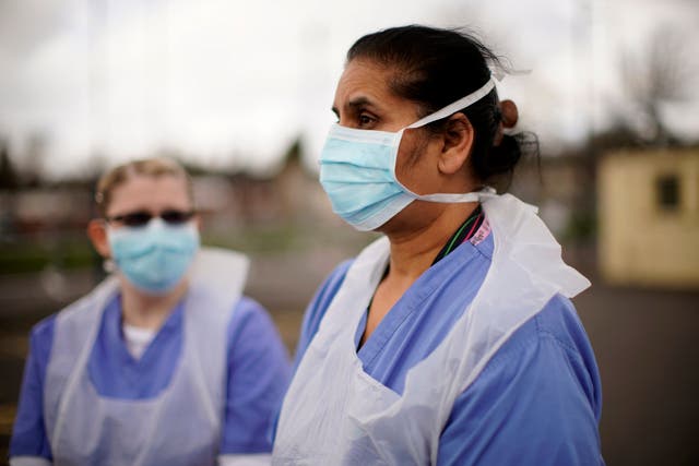 NHS nurses speak to the media as they wait for the next patient at a drive-through coronavirus testing site on 12 March 2020 in Wolverhampton, England.