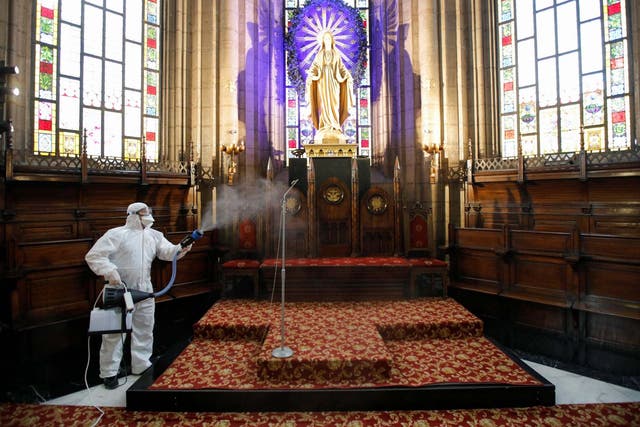 A worker in a protective suit disinfects the St. Antuan Catholic church in Istanbul, Turkey on 16 March 2020.