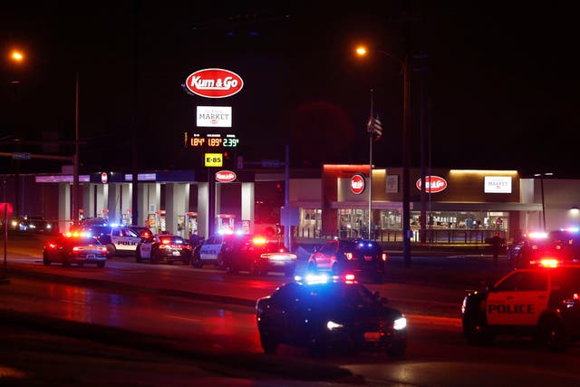 Police cars surround a Kum & Go gas station on East Chestnut Expressway in Springfield, Mo., after a shooting late Sunday, March 15, 2020.