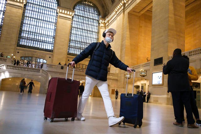 A man wearing a face mask walks through Grand Central terminal in New York City during the coronavirus crisis