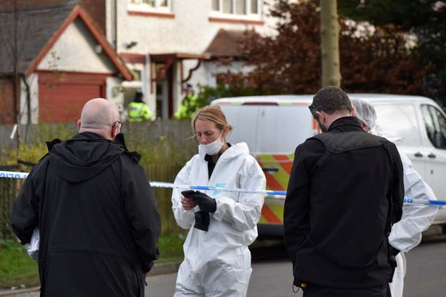 Forensic officers at the scene of a double murder investigation in Moseley, Birmingham