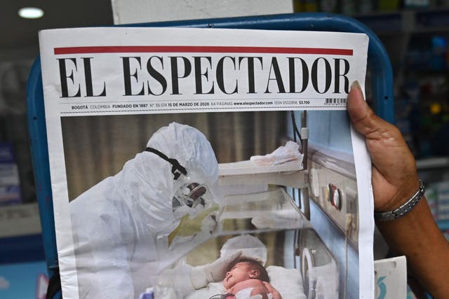 A newspaper shows a story about the coronavirus pandemic at a newsstand in Cali, Colombia on 16 March 2020.