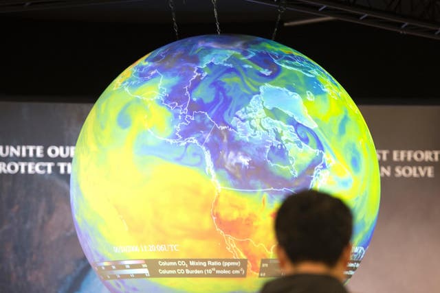 People watch the Earth globe at the COP21, the United Nations conference on climate change