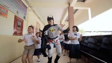 Thai teacher dressed like Batman uses music to fight coronavirus
