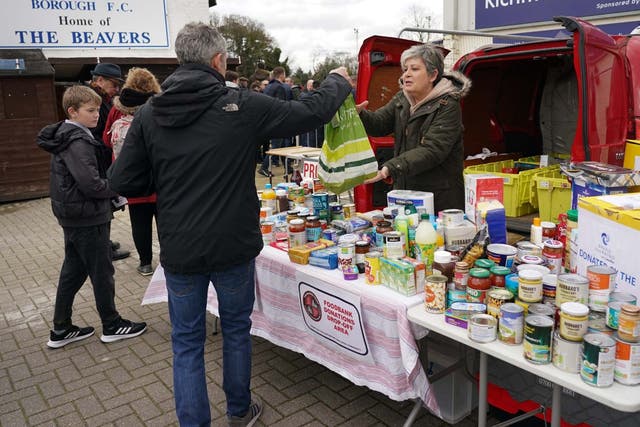 Football fans donate to a food bank in London