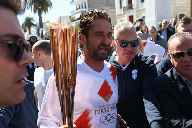 US actor Gerard Butler takes part in the Olympic flame torch relay