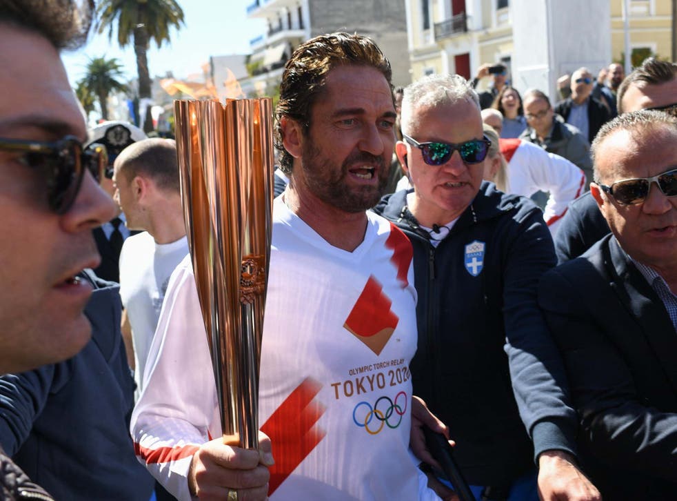 US actor Gerard Butler takes part in the Olympic flame torch relay