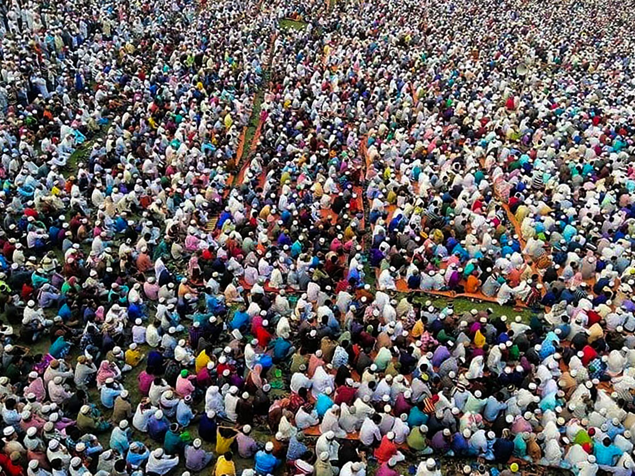 Thousands of Muslims attend a prayer session asking for safety amid concerns over the spread of the COVID-19 novel coronavirus, near Raipur in Lakshmipur district