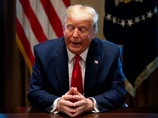 Donald Trump speaks to reporters as he holds a meeting with nurses on the Covid-19 response at the White House in Washington, DC, on 18 March 2020