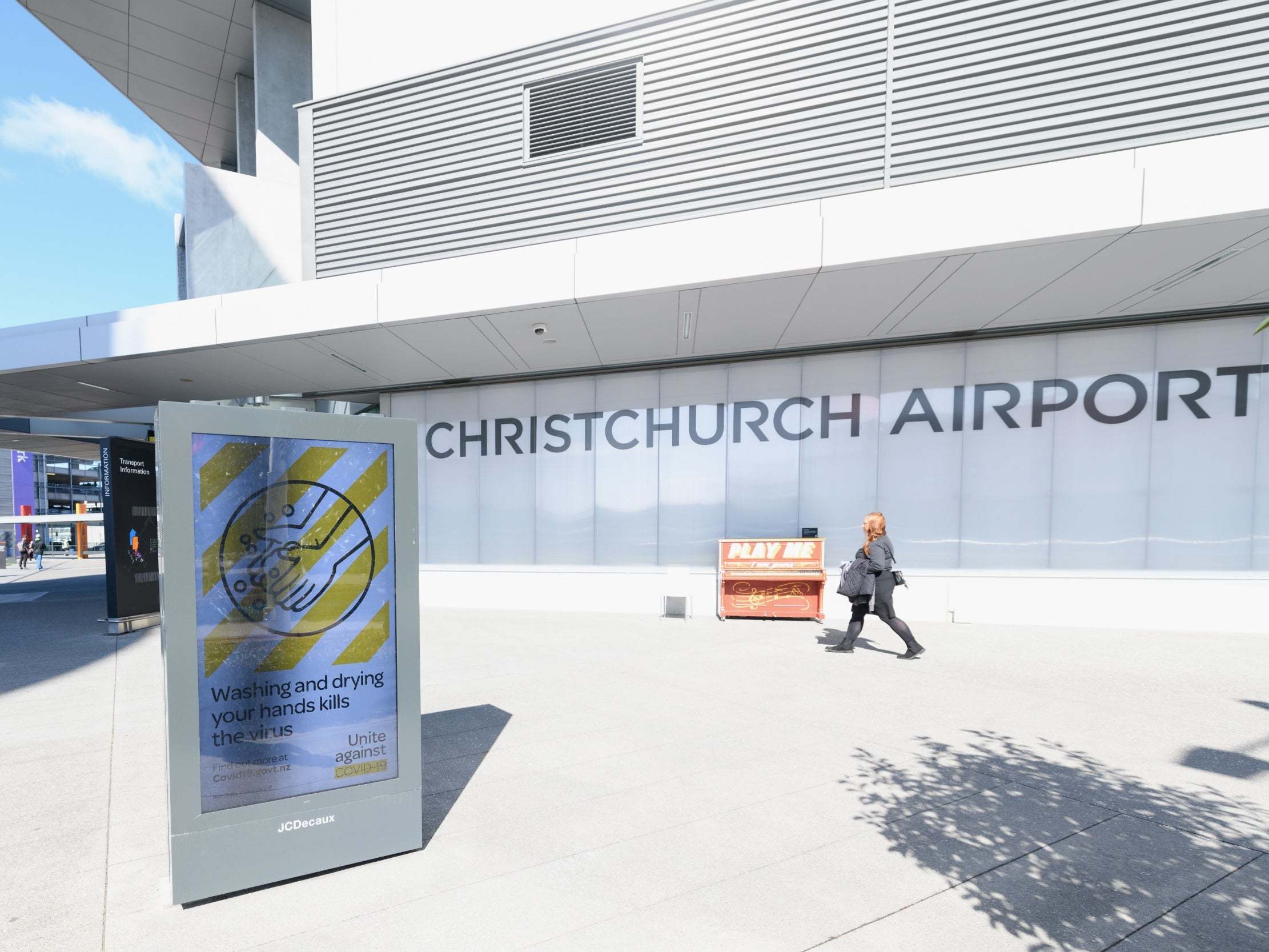 A sign saying washing and drying your hands kills the virus is seen at Christchurch International Airport in Christchurch, New Zealand
