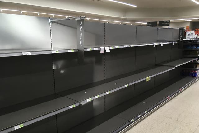 Shelves stand empty in the aisle for toilet rolls, after panic buying as result of the coronavirus, in a branch of the Waitrose supermarket