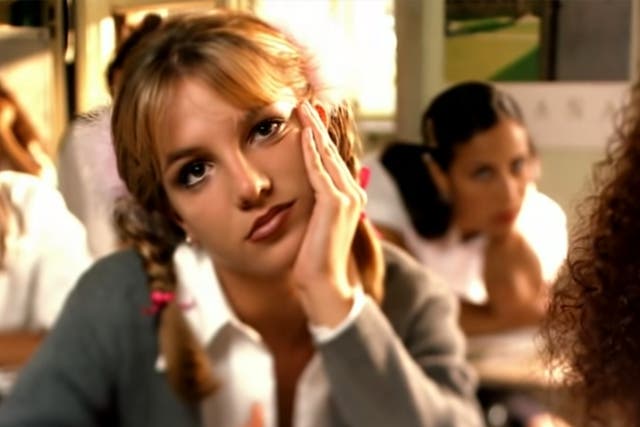 <p>Where it all began: Spears daydreams in the video for her debut single, ‘…Baby One More Time’ </p>