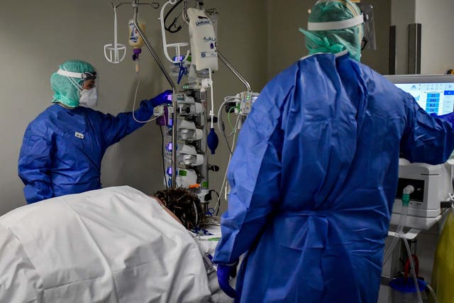 Medical personnel at work in the intensive care unit of the hospital of Brescia, Italy, Thursday, March 19, 2020