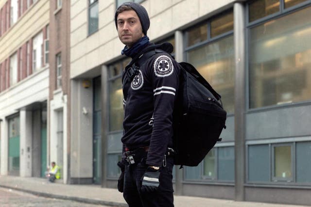 Self-employed courier Alex Marshall, 35, carries medical samples across London