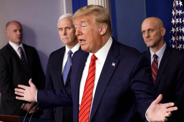 President Donald Trump with Stephen Hahn (right), the FDA commissioner responsible for testing any coronavirus treatments