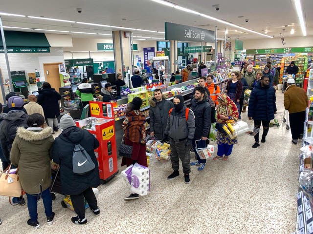 Shoppers queue in the early morning at a Morrison’s supermarket in London on 20 March