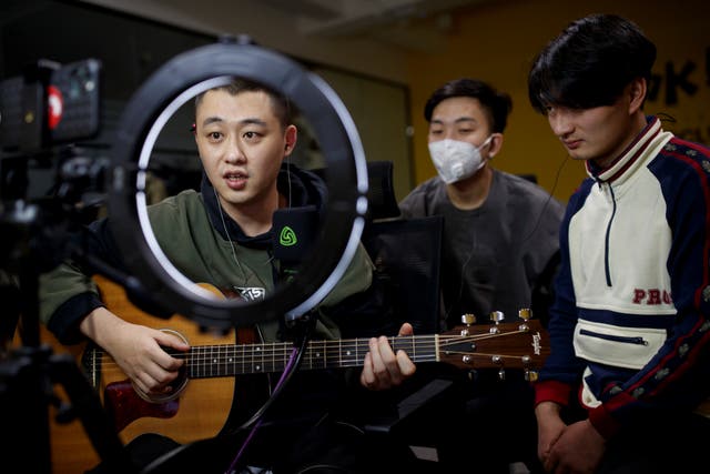 Chinese group The 2econd perform for their fans during a live-streaming session broadcast on the video sharing website Bilibili, at an office in Beijing