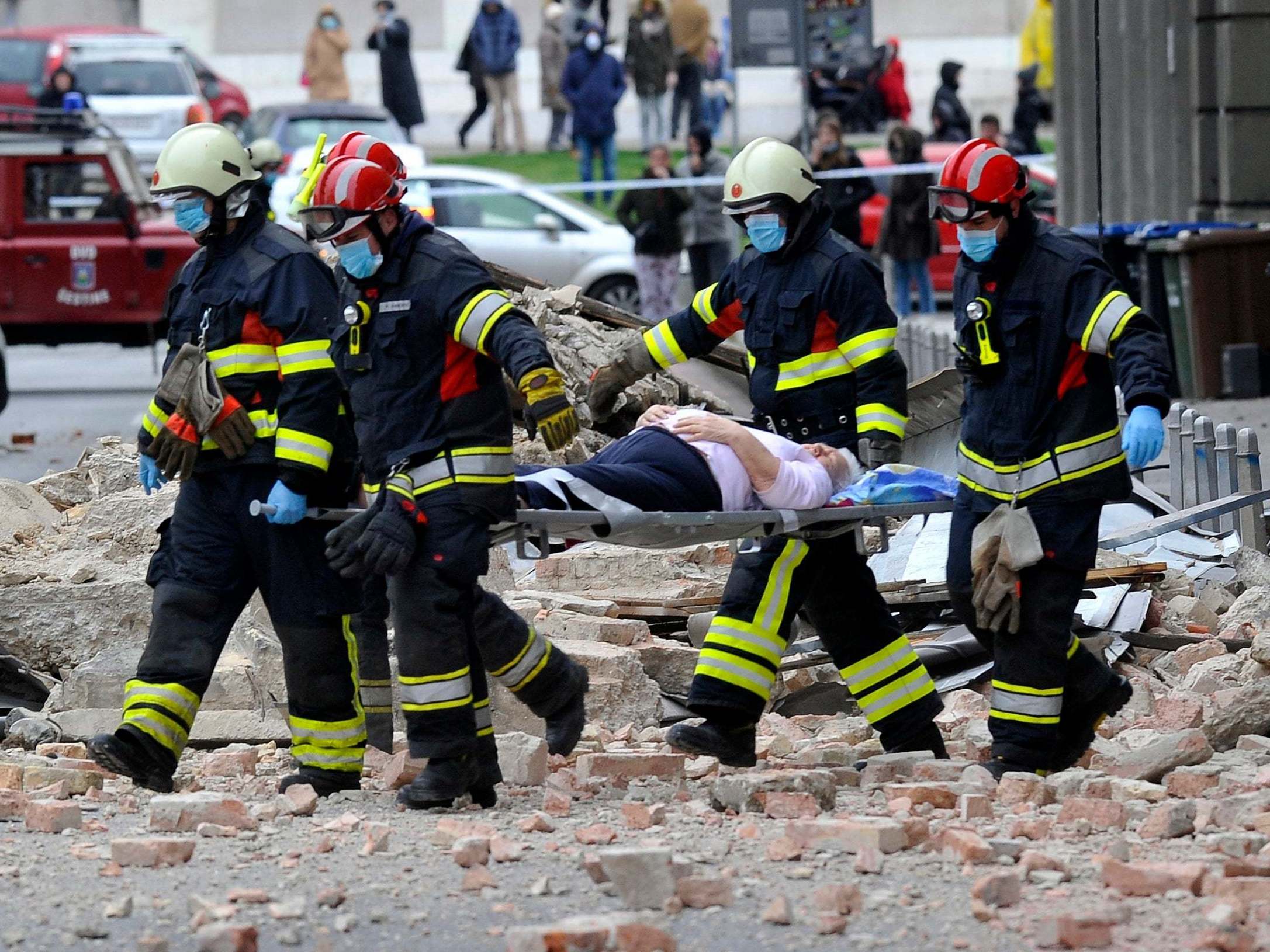 Firefighters rescue a resident in Zagreb after an earthquake hit Croatia