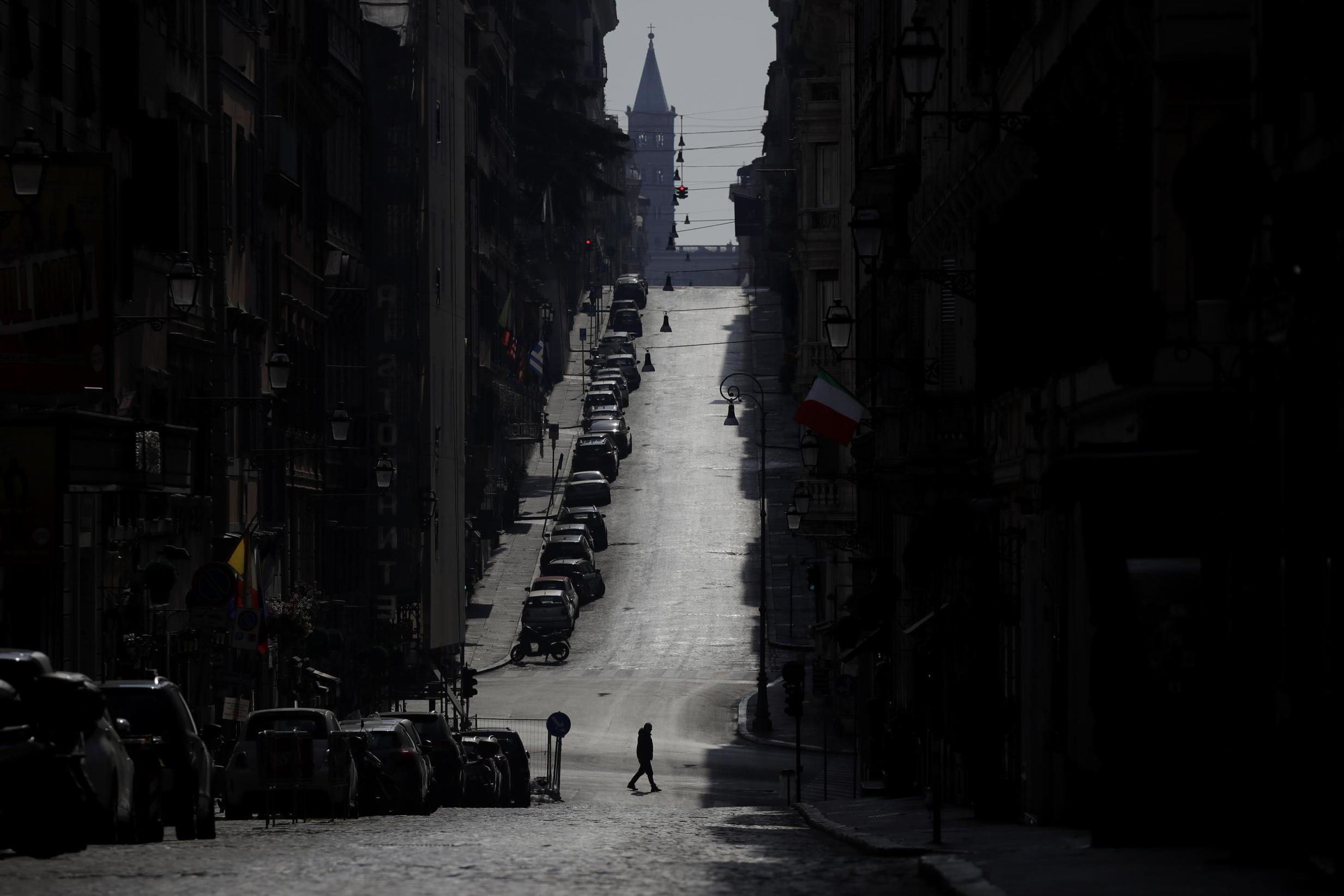 A man walks along an empty road leading to S Mary Major Basilica in Rome whilst Italy is on lockdown