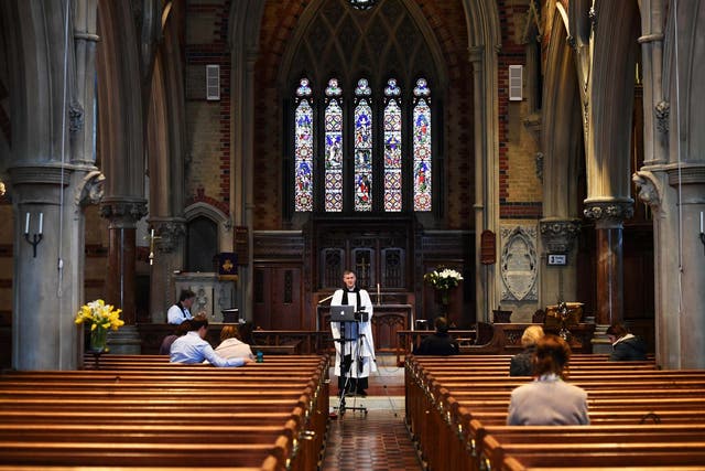 Curate Philip Stewart delivers his service via live stream and to a small congregation at Saint Simon Zelotes in London before the church closed its doors on Sunday night