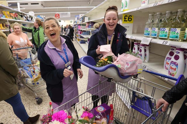 NHS workers laugh as they do their shopping at Tesco supermarket in Newcastle-under-Lyme, 22 March 2020