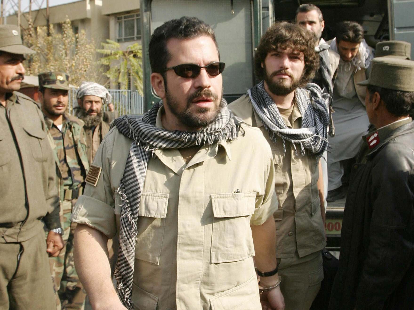 Jack Idema, who was arrested for running a secret prison in Afghanistan, is escorted to a court hearing in Kabul in November 2004 (AFP/Getty)