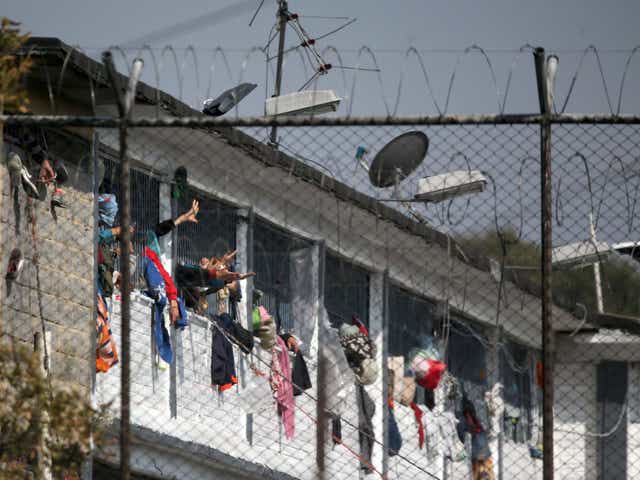 Inmates wave their arms from their cells at the Modelo prison in Bogota as riots flared up at prisons across Colombia