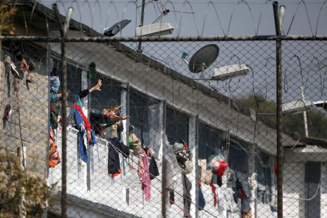 Inmates wave their arms from their cells at the Modelo prison in Bogota as riots flared up at prisons across Colombia