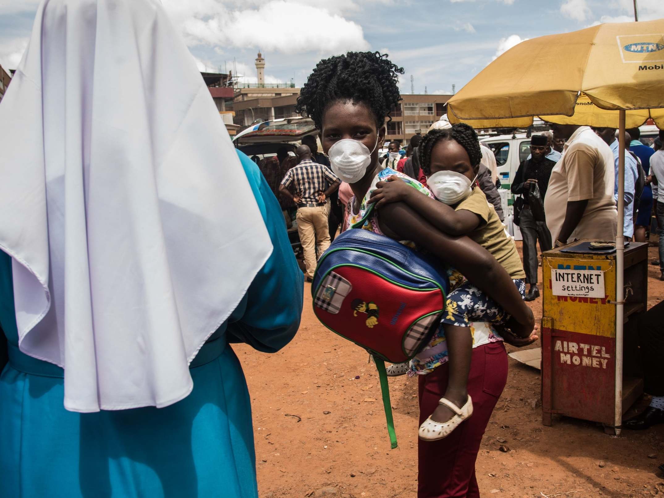 A mother and baby take precautions against coronavirus in Uganda, which saw its first confirmed case over the weekend