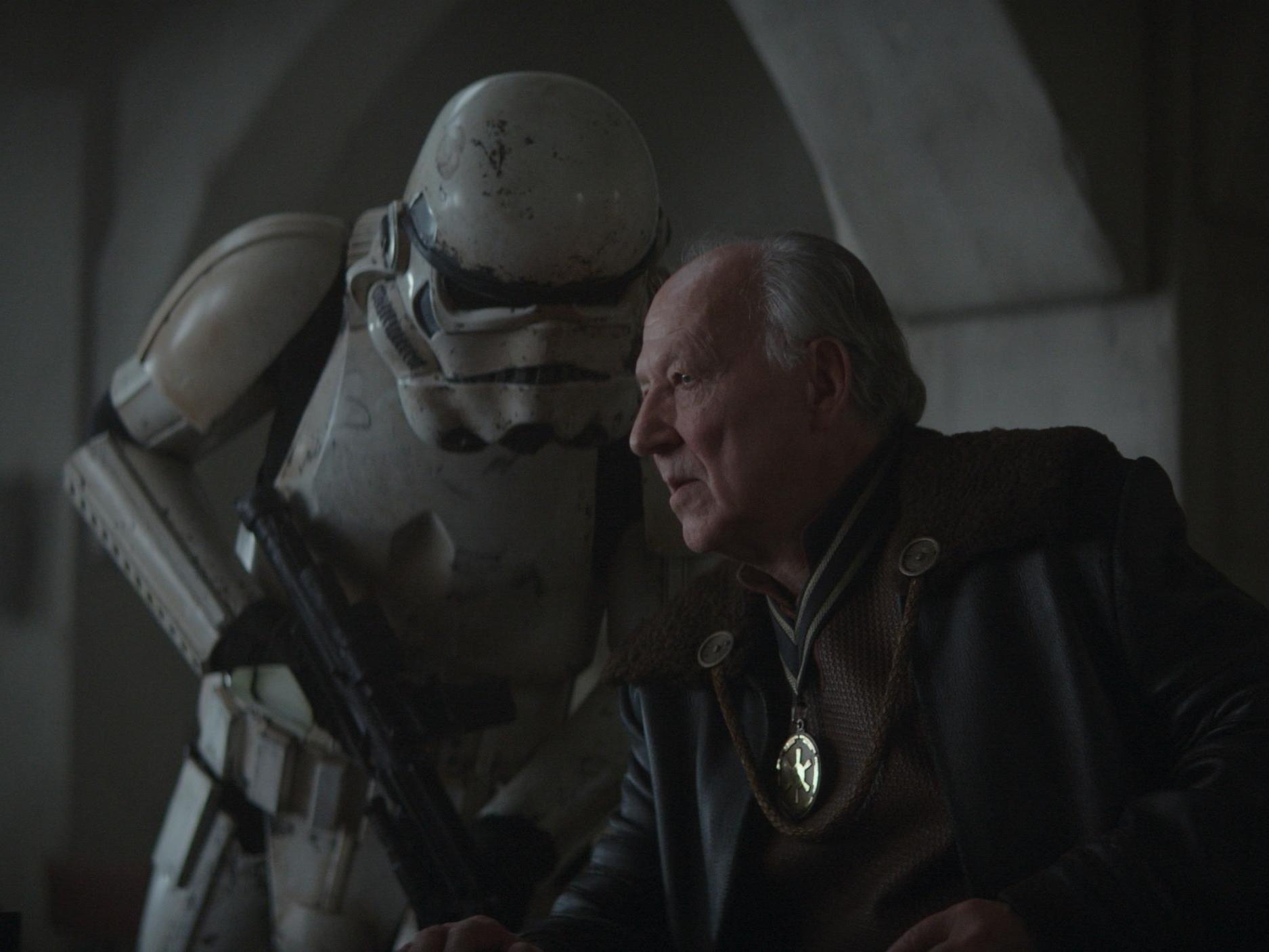 The Client confers with an ex-Imperial Stormtrooper in the penultimate episode of The Mandalorian