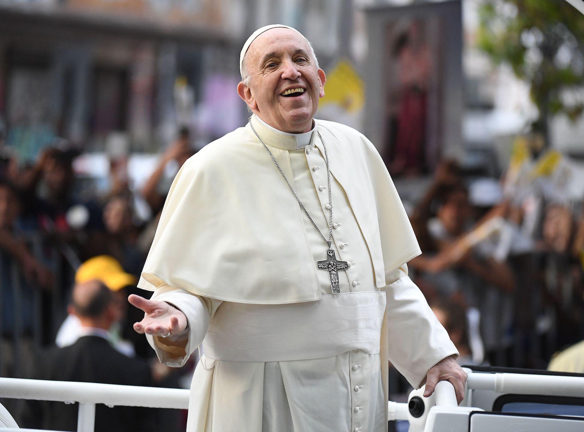 Pope Francis smiles at the faithful from the Popemobile in Santiago, on January 15, 2018