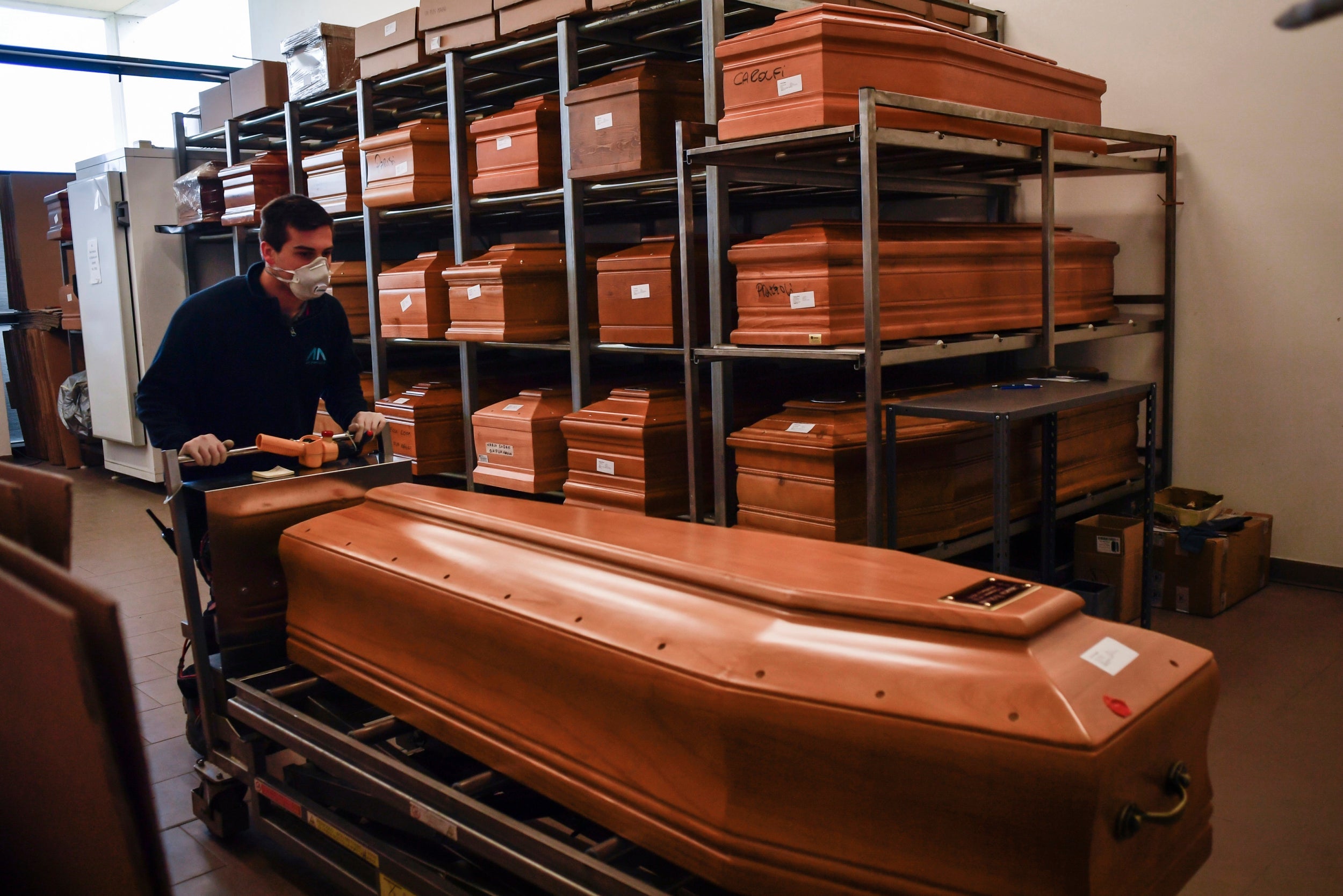Worker moves a coffin in the Crematorium Temple of Piacenza, northern Italy