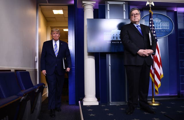 Donald Trump arrives for a White House briefing on the coronavirus pandemic as Attorney General William Barr looks on