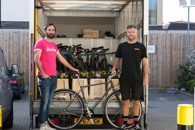 Tom Hares (left), CEO of Buzzbike, and Steve Coombes, a mechanic, dropping off bikes to NHS workers in London
