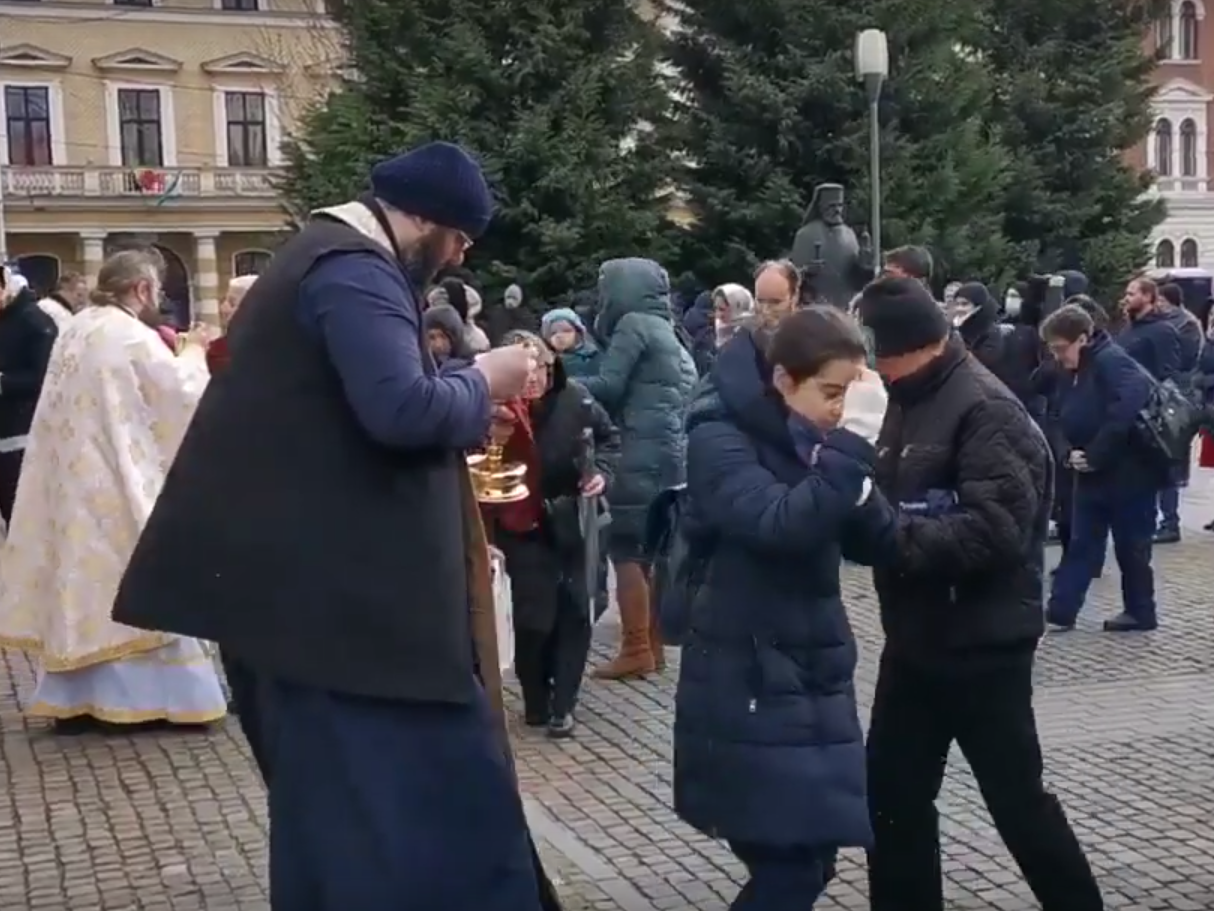 Romanian priests give communion with a shared spoon on 22 March, 2020, amid concern over coronavirus.
